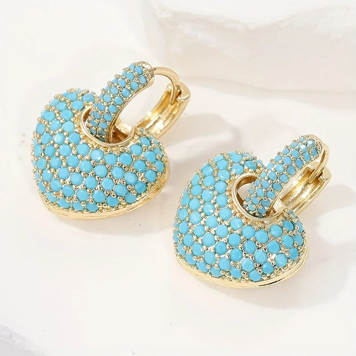 Turquoise hartvormige oorbellen met pavésluiting