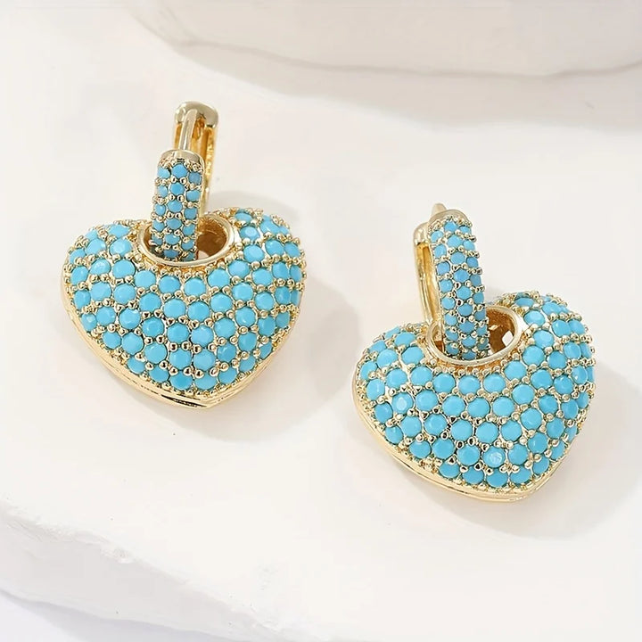 Turquoise hartvormige oorbellen met pavésluiting