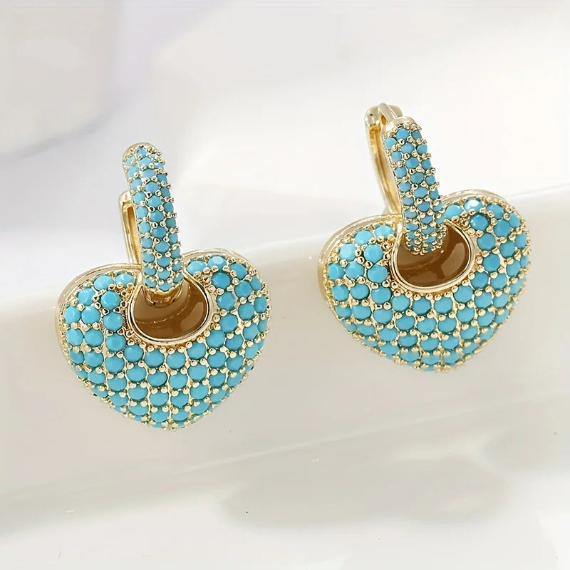 Turquoise hartvormige oorbellen met pavésluiting
